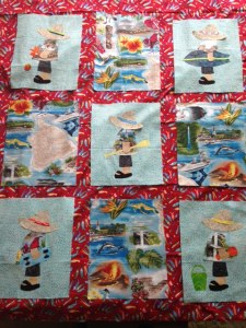 My version of a Hawaiian appliqué quilt.  Each of the boys decided what they wanted their own square to look like and the other 4 squares depict Big Island landmarks.  The red background is a Boys Day print.
